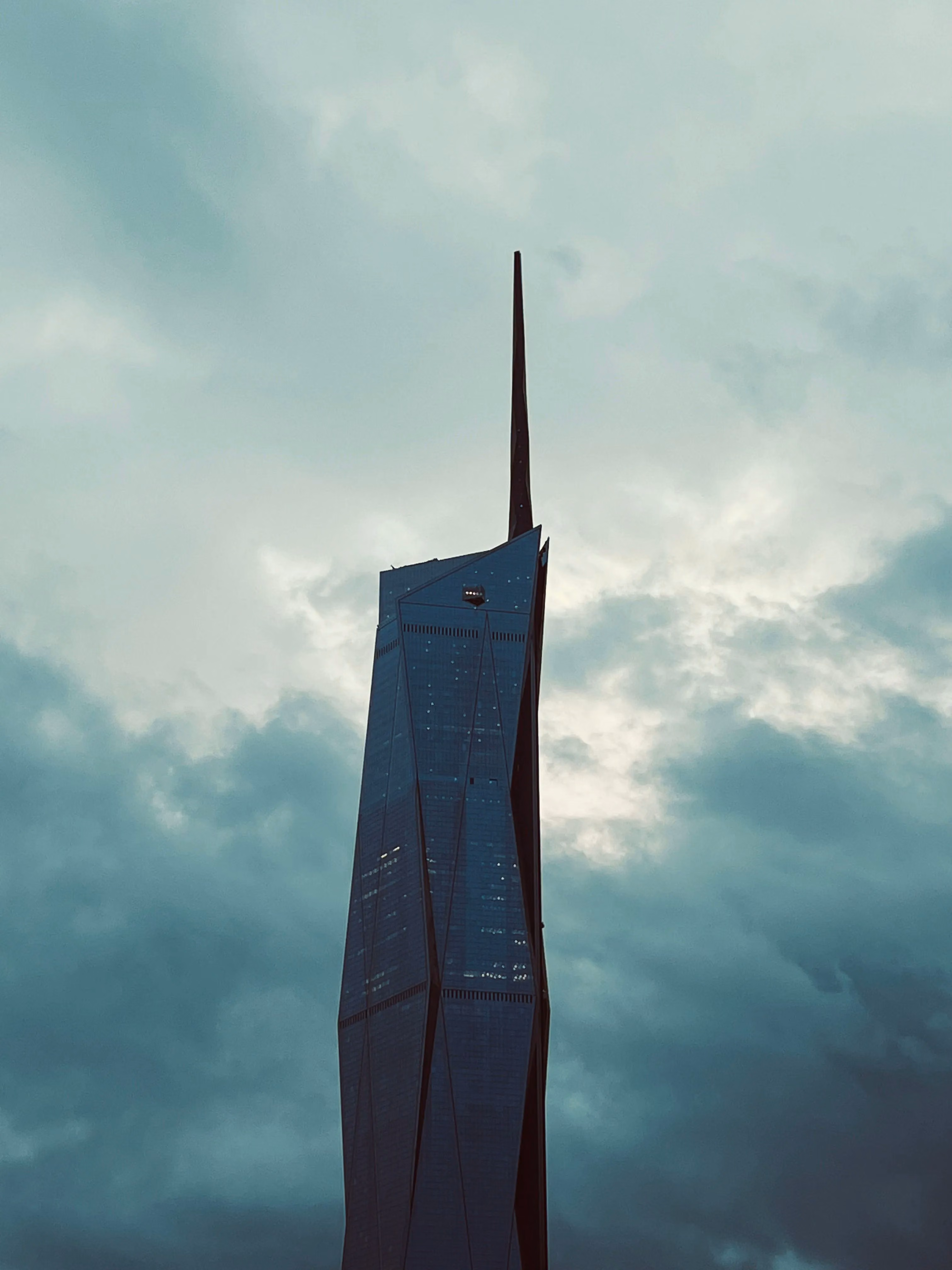 Merdeka 118 silhouetted against clouds
